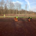 A community service volunteer cleans up the baseball and softball fields at Crooksville Village Park.