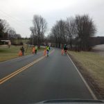 Four community service volunteers clean up Panther Drive in New Lexington.