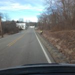 A community service volunteer cleans up Tunnel Hill road in Crooksville.